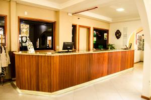 a lobby with a wooden reception counter in a store at Urubici Park Hotel in Urubici