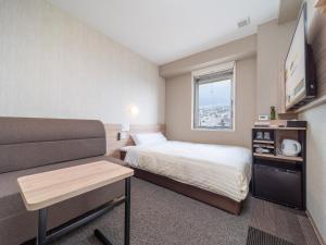 Postel nebo postele na pokoji v ubytování Super Hotel Iyo Saijo