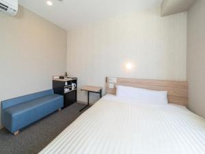 Postel nebo postele na pokoji v ubytování Super Hotel Iyo Saijo