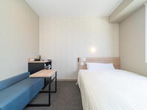 Postel nebo postele na pokoji v ubytování Super Hotel Iyo Saijo