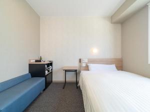 Postel nebo postele na pokoji v ubytování Super Hotel Iyo Saijo