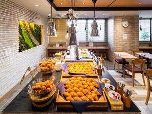 a buffet line with oranges on display in a restaurant at Super Hotel Iyo Saijo in Saijo