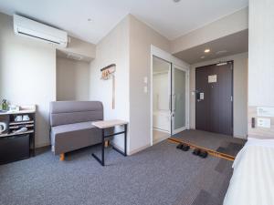 Postel nebo postele na pokoji v ubytování Super Hotel Iyo Saijo