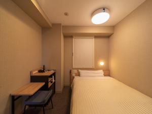 Postel nebo postele na pokoji v ubytování Super Hotel Iyo Saijo
