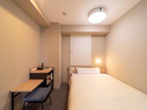 Postel nebo postele na pokoji v ubytování Super Hotel Iyo Saijo