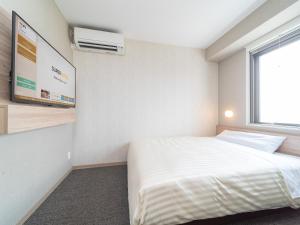 Postel nebo postele na pokoji v ubytování Super Hotel Iyo Saijo