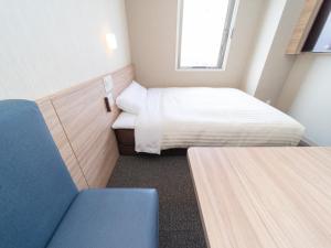 Postel nebo postele na pokoji v ubytování Super Hotel Iyo Saijo