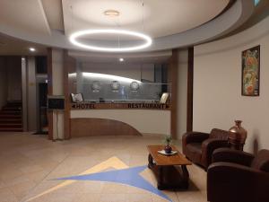 a lobby with a waiting room with a table and chairs at Hotel Astoria City Center in Iaşi