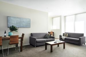 a living room filled with furniture and a couch at Punthill Knox in Wantirna South