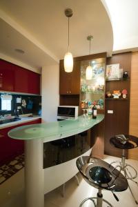 a kitchen with a island with a green counter top at Ken's Joy Inn in Kaohsiung