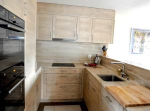 a kitchen with wooden cabinets and a sink at Luxury Grimentz Apartment in Grimentz