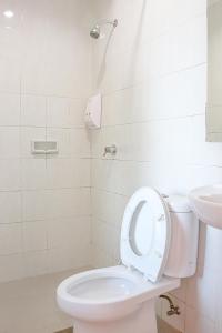 y baño con aseo y lavamanos. en LeGreen Suite Ratulangi, en Ambon