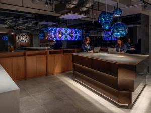 two women sitting at a bar with their laptops at The Lively Osaka Honmachi in Osaka +43 photos