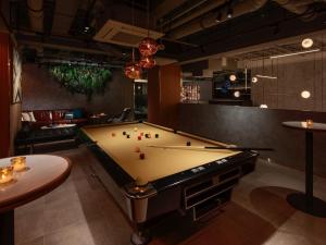 a pool table in a room with a bill at The Lively Osaka Honmachi in Osaka