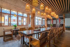 a dining room with a long table and chairs at Ridge Inn in Longsheng