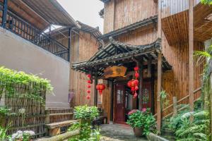 an old building with red lanterns in front of it at Ridge Inn in Longsheng