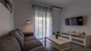 sala de estar con sofá y mesa en Apartamento Santa Justa, en Sevilla