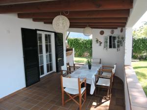 a dining room with a table and chairs on a patio at Chalet Cerca de la Playa in Cala'n Bosch