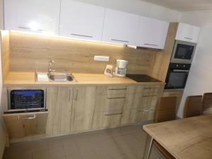 a kitchen with white cabinets and a sink at vila krkonoše in Černý Dŭl
