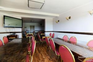 a conference room with tables and chairs and a projection screen at Pokoje Gościnne Via Steso in Gdańsk