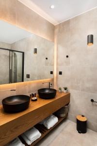 a bathroom with a sink and a mirror at Lignum Suites Chania in Chania Town