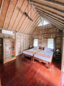 Postel nebo postele na pokoji v ubytování Umah Kayu Ubud