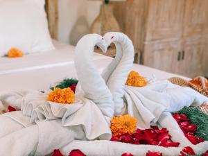 Postel nebo postele na pokoji v ubytování Umah Kayu Ubud