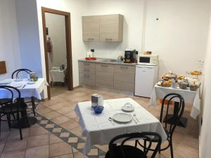 a kitchen with two tables and a kitchenasteryasteryasteryasteryasteryasteryasteryastery at La Tegola in Como