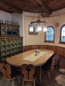 a dining room with a wooden table and chairs at Landgasthof Braun in Mindelstetten