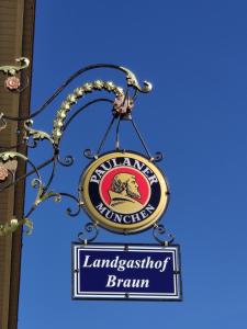 a sign for a lancashirean firm hanging from a building at Landgasthof Braun in Mindelstetten