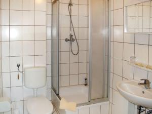 a bathroom with a shower and a toilet and a sink at Apartment Old Hüsung - MUZ322 by Interhome in Mirow