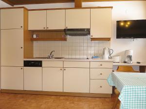 a kitchen with white cabinets and a sink at Apartment Schuler - STA123 by Interhome in Nasserein