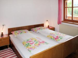 a bed in a room with two pillows on it at Apartment Zollerhof - OLA192 by Interhome in Valdaora di Sotto