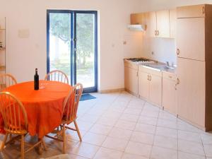 a kitchen and dining room with a table and chairs at Apartment Blazina-2 by Interhome in Ravni