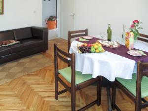 a dining room table with a plate of fruit on it at Apartment Branka - MOD205 by Interhome in Mošćenice