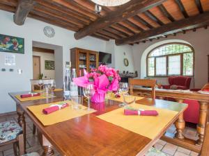 a dining room with a table with pink flowers on it at Holiday Home Le Terrazze by Interhome in Civitella in Val di Chiana