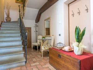 a living room with a staircase and a table at Holiday Home Le Terrazze by Interhome in Civitella in Val di Chiana +24 photos