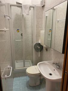 a bathroom with a shower and a toilet and a sink at Hotel Nuovo Metropol in Albissola Marina