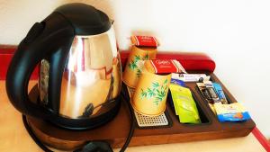 a tea kettle sitting on top of a table at Modern'Hotel in Valenciennes