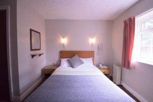 Postel nebo postele na pokoji v ubytování Pinegrove Hotel