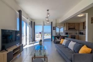 a living room with a couch and a table at Haravgi 3 Bedrooms Villa in Agia Triada