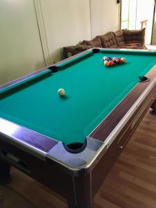 a pool table in a living room with afits at Mátrai Vadászház 2 in Mátraterenye