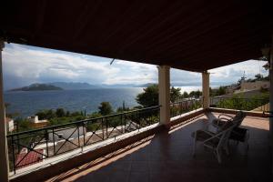 a view of the ocean from the balcony of a house at Amazing view family house! in Kapótidhes