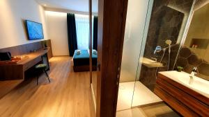 a bathroom with a shower and a sink and a desk at Petkovšek Rooms and Apartments in Ljubljana