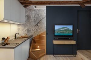 a kitchen with a tv on a blue wall at Studio74 in Annecy
