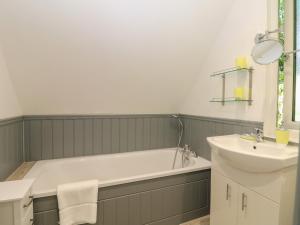 a bathroom with a bath tub and a sink at 32 Trevithick in Hayle +15 photos