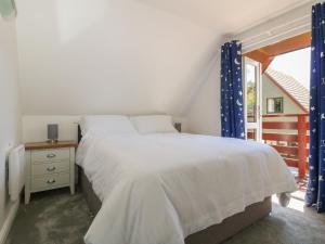 a bedroom with a white bed and a window at 32 Trevithick in Hayle