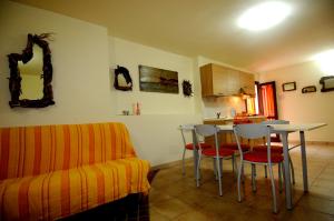 a living room with a couch and a table and chairs at Il Sogno di Alghero - Adults Only in Alghero
