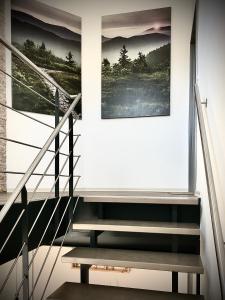 a staircase with two pictures on the wall and a stair case at Dilger Apartments in Rust