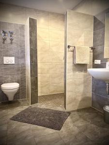 a bathroom with a shower and a toilet and a sink at Dilger Apartments in Rust +38 photos